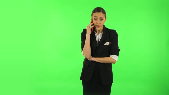 Woman Speaking Via Telephone Looking Boredon. Green Screen