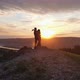 Silhouettes of a Pair of Young Men Kissing on Top of a Mountain at Sunset - VideoHive Item for Sale