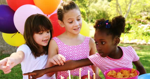 Kids counting a food item in park alt