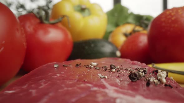 Zoom out macro video of black pepper on raw steak. Shot with RED helium camera in 8K