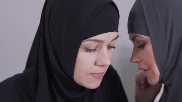 Close-up Face of Shocked and Surprised Muslim Woman Listening To Gossips. Two Adult Eastern Women
