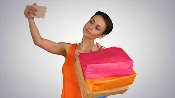 Attractive young woman holding different blank shopping bags