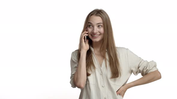 Video of Adult Blond Woman in Casual Blouse Picking Up Phone and Starting Conversation Having Braces