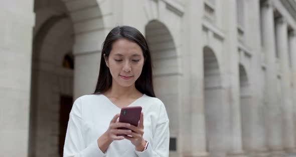 Woman use of mobile phone in city