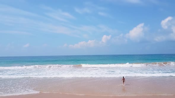 Asian Woman Feet Walking Barefoot Beach at Endless Ocean Seaside Leaving Footprints in Sand