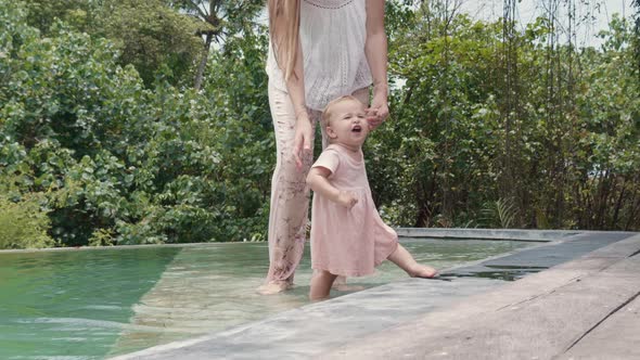 Caucasian Toddler Stepping out of Pond