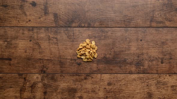 Diffeerent Kind of Nuts Increasing From One to Handful Wooden Background Stop Motion Animation