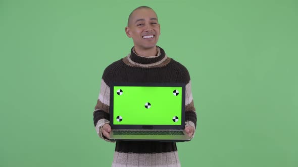 Happy Bald Multi Ethnic Man Thinking While Showing Laptop and Talking