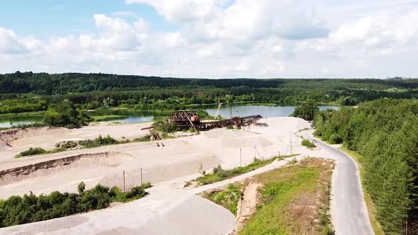 Gravel and sand quary with industrial equipment in vibrant aerial drone view