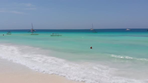 Aerial View Woman in Clear Turquoise Ocean on Paradise Sandy Beach Zanzibar