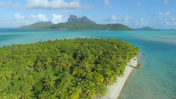 Aerial drone view of a deserted island near Bora Bora tropical island.