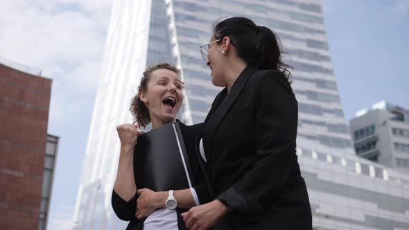 Two Happy Professionally Fulfilled Female Managers From Different Ethnic Backgrounds in Front of