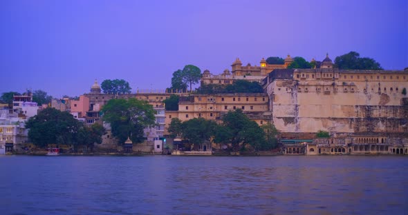 Udaipur City at Sunset: Houses, Ghat and City Palace on Lake Pichola. Rajasthan, India. Horizontal