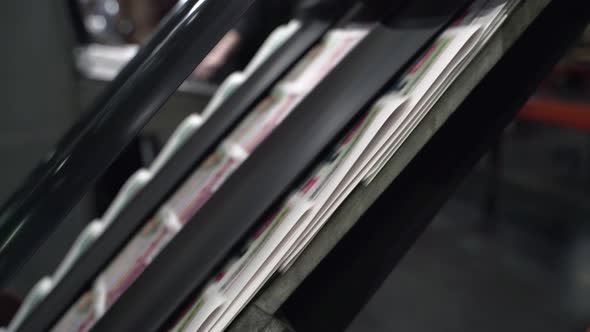 Printed Newspapers are Moved Along Conveyor