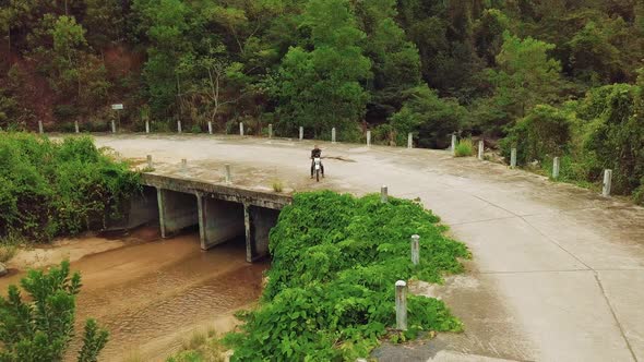 Aerial View of Motorbiker with Bike Parking on Bridge in the Jungle River.