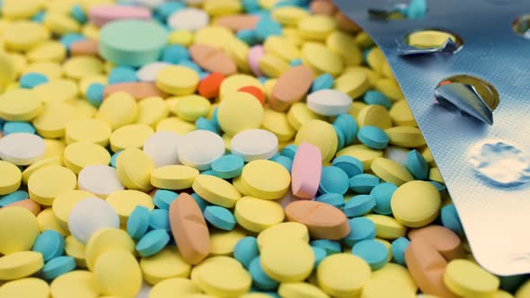 Bright Multi-colored Medicines Lie with an Open Blister of Painkillers.