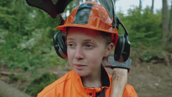 Portrait of a Female Logger Standing in the Forest a Young Specialist Woman in Protective Gear Works