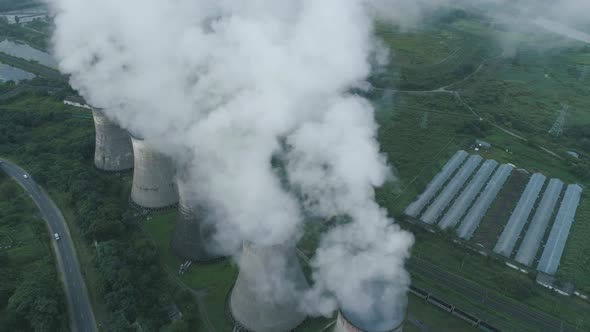 Aerial Drone View of Smoking Pipes and Cooling Towers of Coal Thermal Power Plant alt