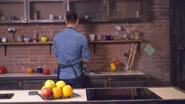 Boyfriend Holding Clean Dish Girlfriend Coming in Room.