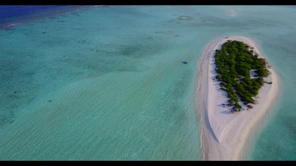 Aerial flying over sky of tropical tourist beach adventure by shallow ocean with white sandy backgro