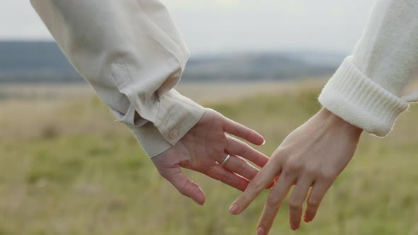 Close Up of Two Loving Women Holding Hands Outdoors