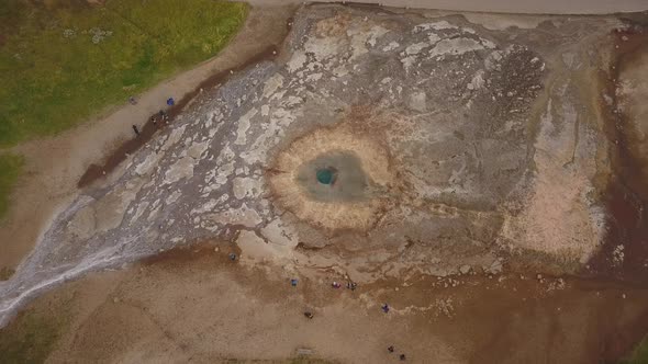 A drone footage of a geyser erupting from above in Iceland