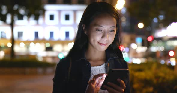 Woman use of mobile phone at night 