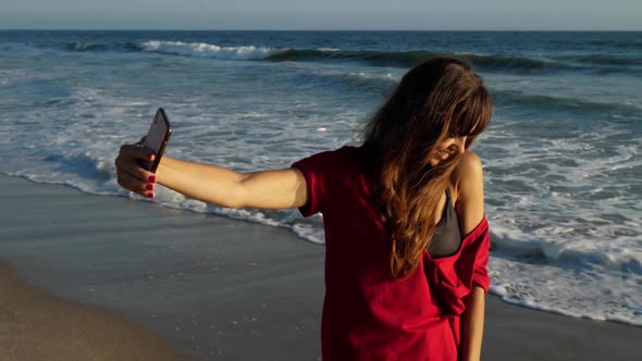 Attractive woman taking a selfie at the beach