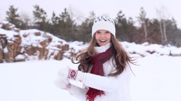Winter Girl Trows Snowball at Camera alt