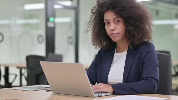 Young African Businesswoman with Laptop Shaking Head in Approval Yes
