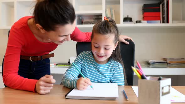 Mother helping her daughter with homework 4k