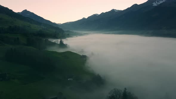 Fog in a valley during sunset in the mountains