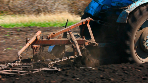 Tractor Plowing At Spring