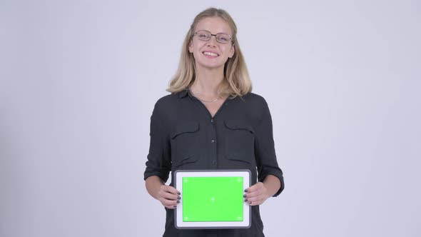 Young Happy Pregnant Businesswoman Showing Digital Tablet on Belly
