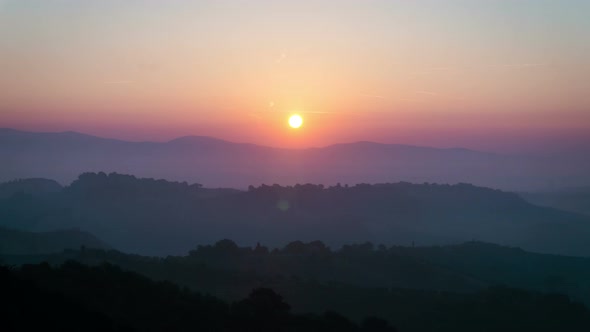 Sunrise time lapse over hills and mountains