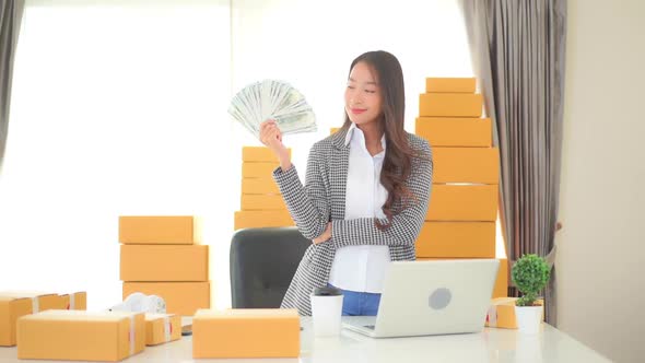 Young asian woman with a lot of money and cash