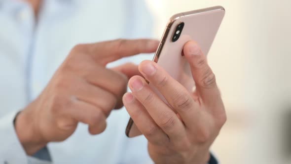 Close Up of African Man Using Smartphone