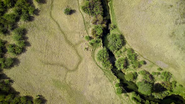 Aerial Of A Winding River Through A Meadow