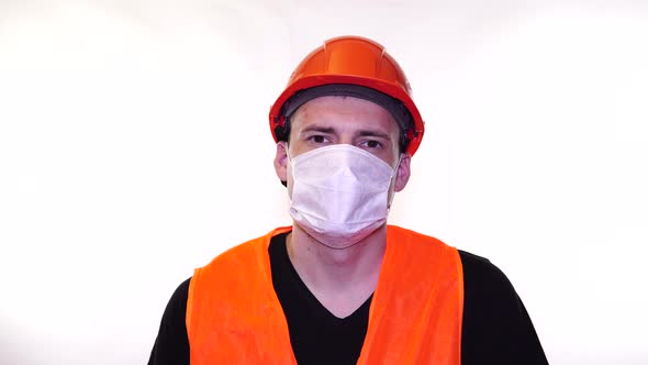 Portrait of Young Man in Medical Mask on His Face on White Background