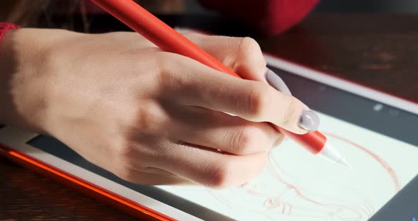 Close Up Female Designer Sitting and Working at Desk. Contemporary Young Woman Drawing and Using Pen