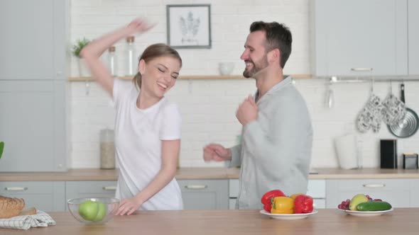 Woman and Man Dancing in Kitchen