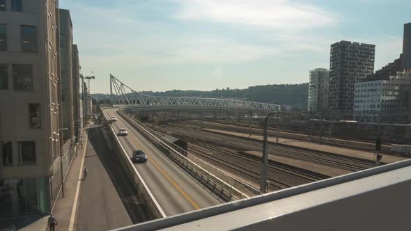 Busy commuter road traffic and trains in Oslo city centre, time lapse