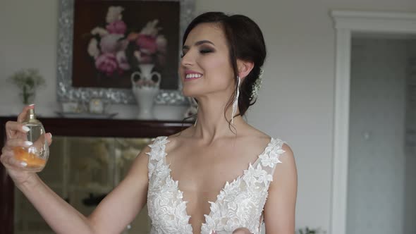 Happy Bride Applies Perfume To Her Skin