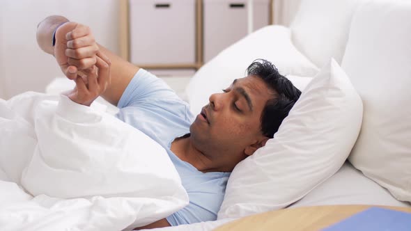 Indian Man with Tracker Sleeping in Bed at Home