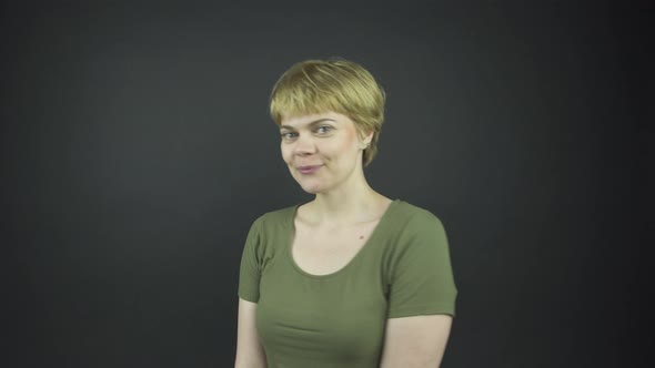 Beautiful Lady in Green T-shirt Moves and Touches Face