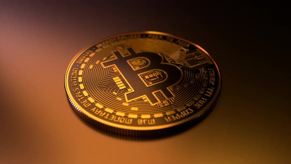 Golden bitcoin slowly rotating on goldish floor