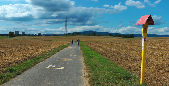 People with Bicycle in the Field