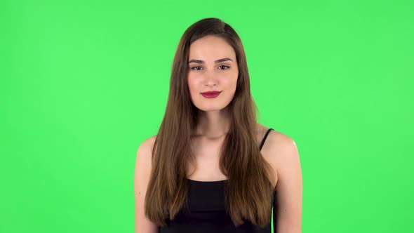 Female Stands Worrying in Expectation Then Smiles with Relief, Carried. Green Screen