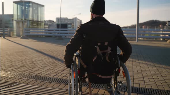 Handicapped Man in Wheelchair in the Street with Elevator