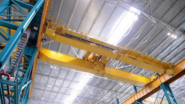 Factory Crane Moves on Top of a Large Workshop